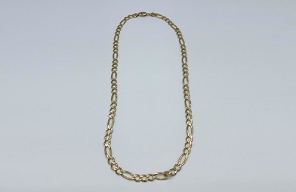 A chain necklace on display with a grey background.