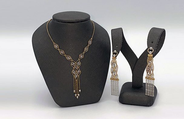 An ensemble on display with a grey background.