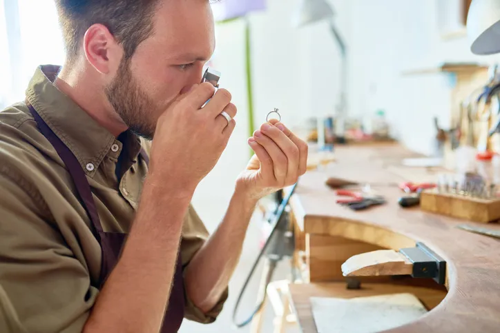 An EZPAWN team member is inspecting a diamond for authenticity.