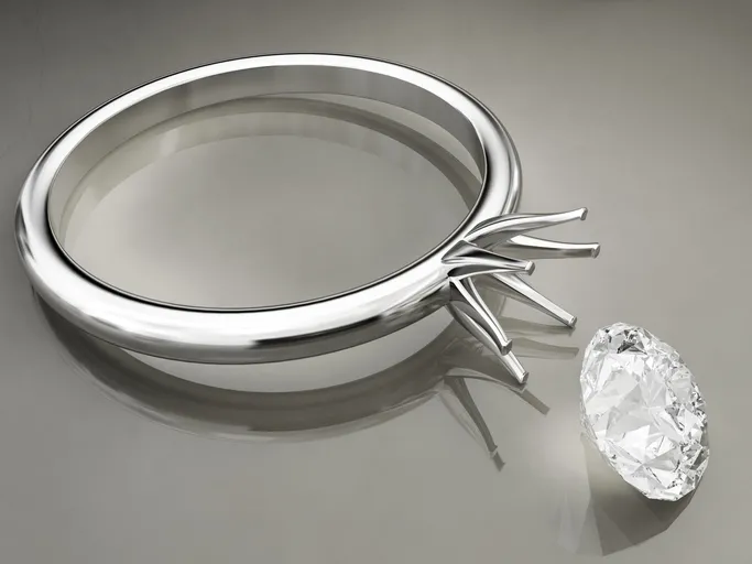 An unset diamond and a ring with a grey background.
